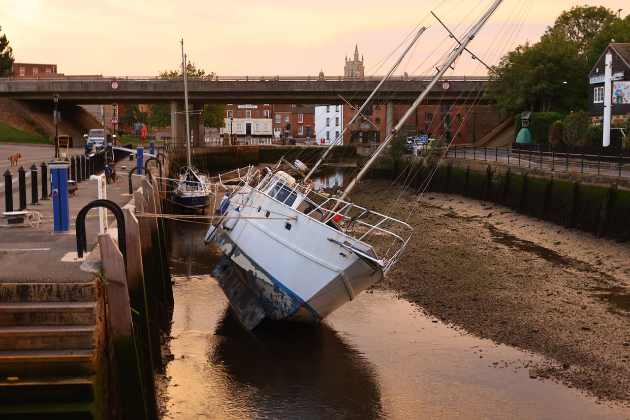 FALLING TIDE LEAVES BOAT LISTING HEAVILY AT NEWPORT QUAY